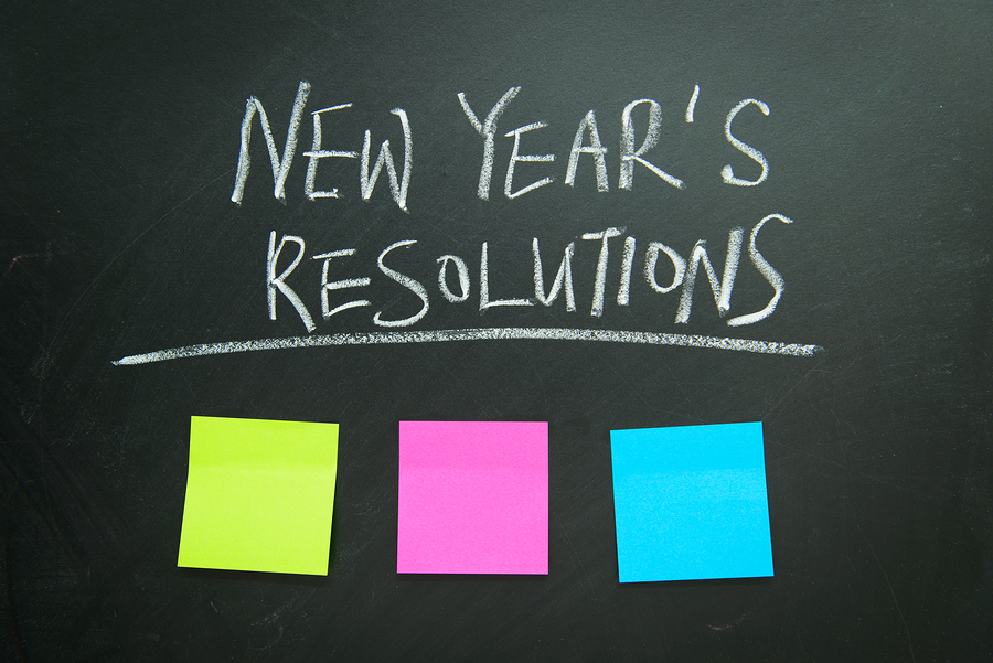 The word New Year's resolution written on the blackboard with blank notes